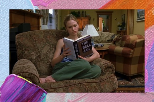 30 coisas que só pessoas viciadas em livros entendem Uma mulher branca e loira, por volta dos 20 anos, sentada numa poltrona marrom e lendo um livro