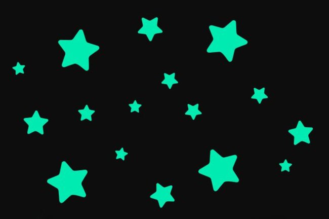 Foto de adesivos de estrelas verde neon num fundo preto