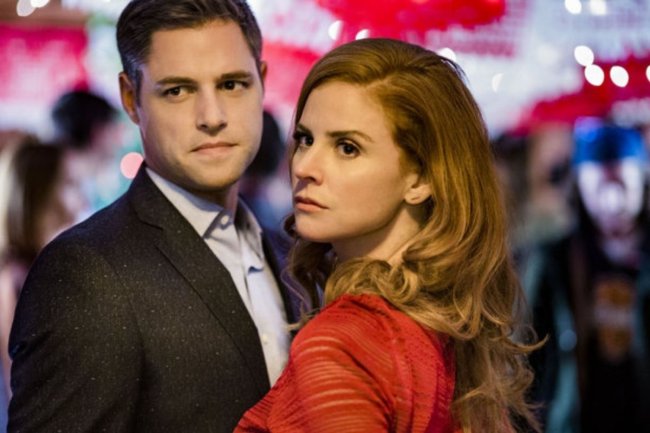 all-things-valentine Casal próximo um ao outro. A mulher está com roupa vermelha e cabelos ruivos, enquanto o homem está de terno.