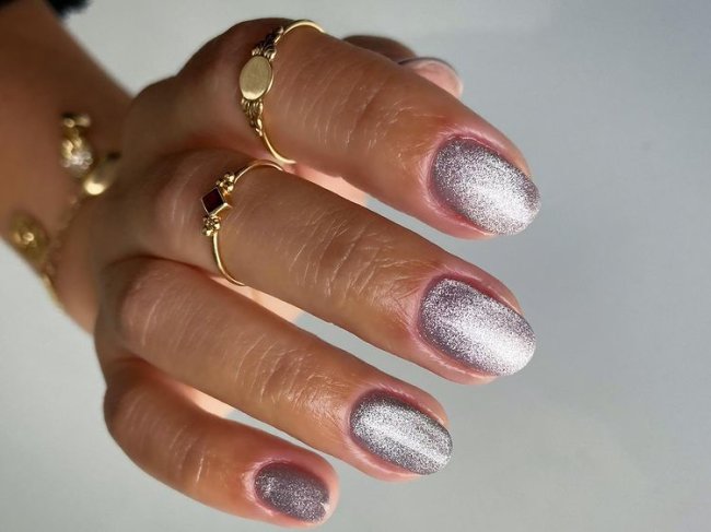 unhas-metalizadas-aveludadas Foto de uma mão com as unhas médias com nail art aveludada com esmalte prata.