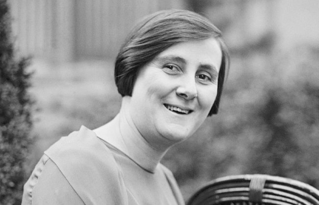 Curiosidades sobre a conquista do direito ao voto feminino no Brasil Foto em preto e branco de Bertha Lutz, famosa política e siplomata brasileira. Ela está sentada, de lado, e sorri para a câmera. Ela tem o cabelo chanel liso