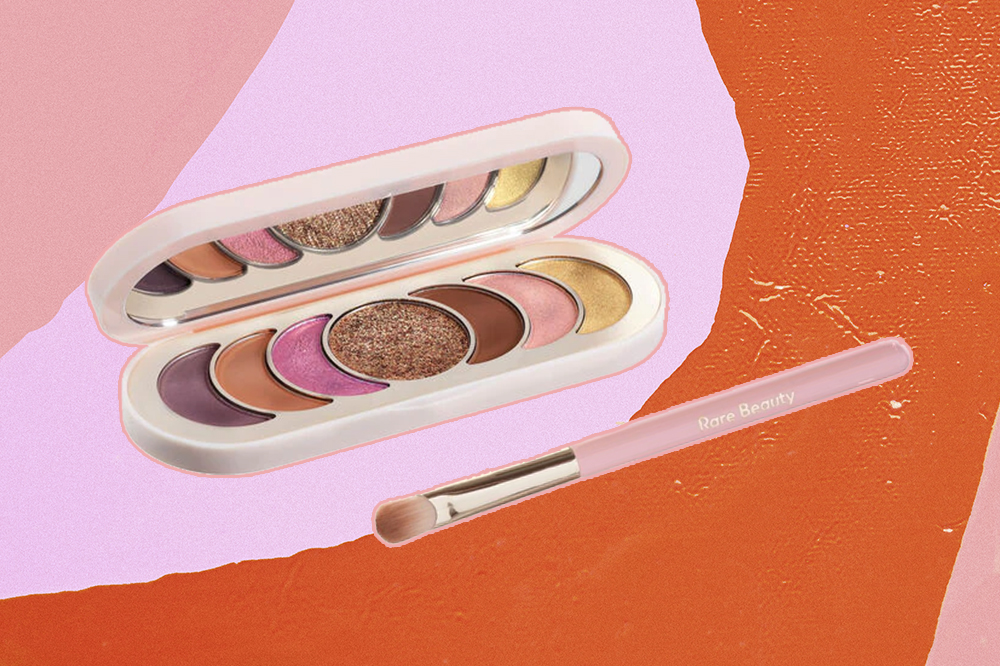 testamos-produtos-maquiagem-rare-beauty-paleta-sombras Paleta de sombras True To Myself e pincel de olhos Stay Vulnerable, da Rare Beauty, em fundo rosa e laranja