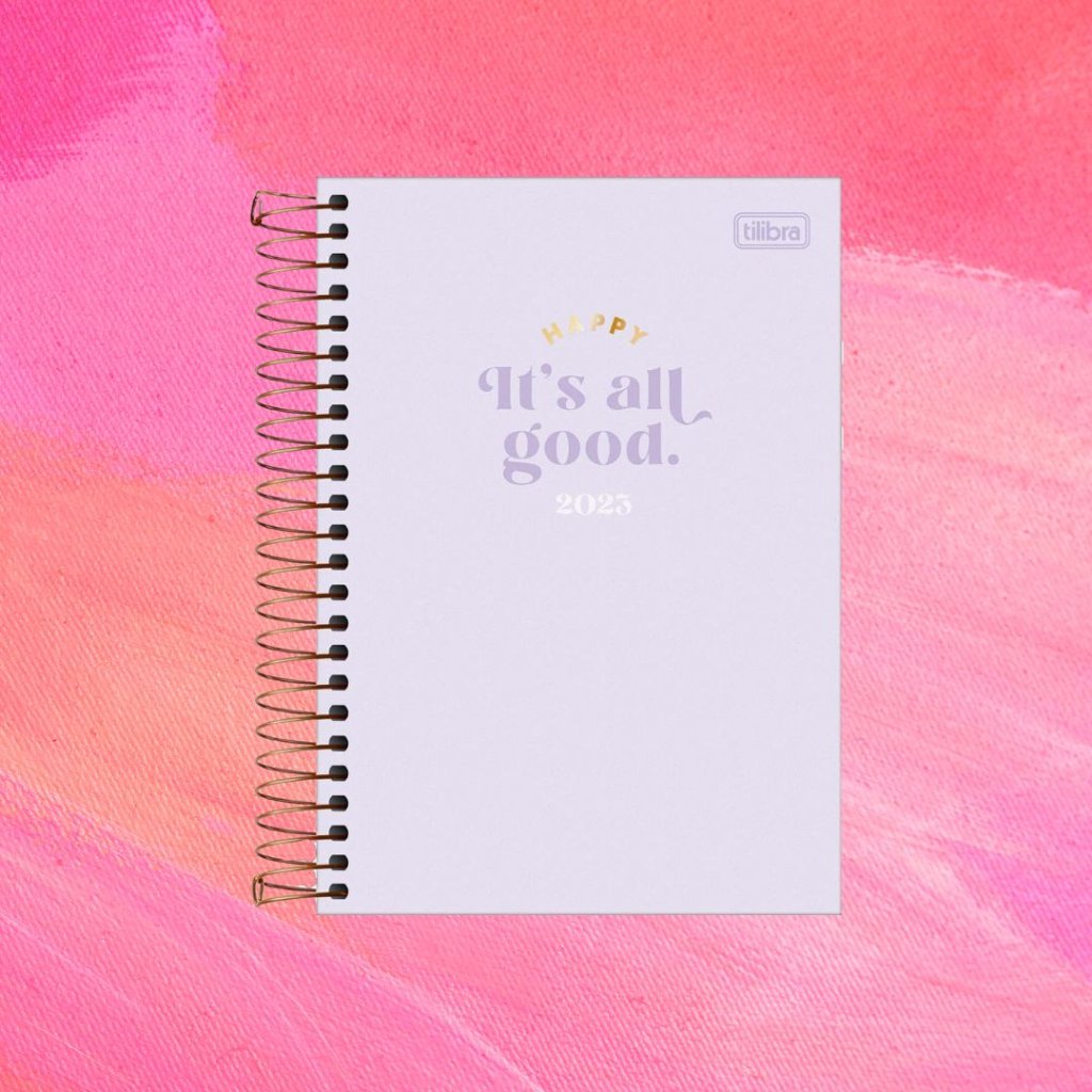 planner (7) Planner lilás com texto "Happy/It's All Good/2023" em dourado, roxo e branco; o fundo é uma textura em tons de rosa e branco