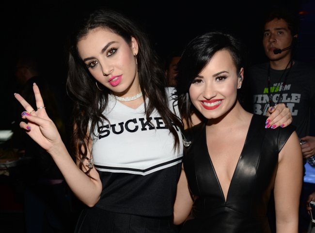 As cantoras Charli XCX (E) e Demi Lovato comparecem ao Jingle Ball 2014 da KIIS FM, promovido pela LINE, no Staples Center, em 5 de dezembro de 2014, em Los Angeles, Califórnia